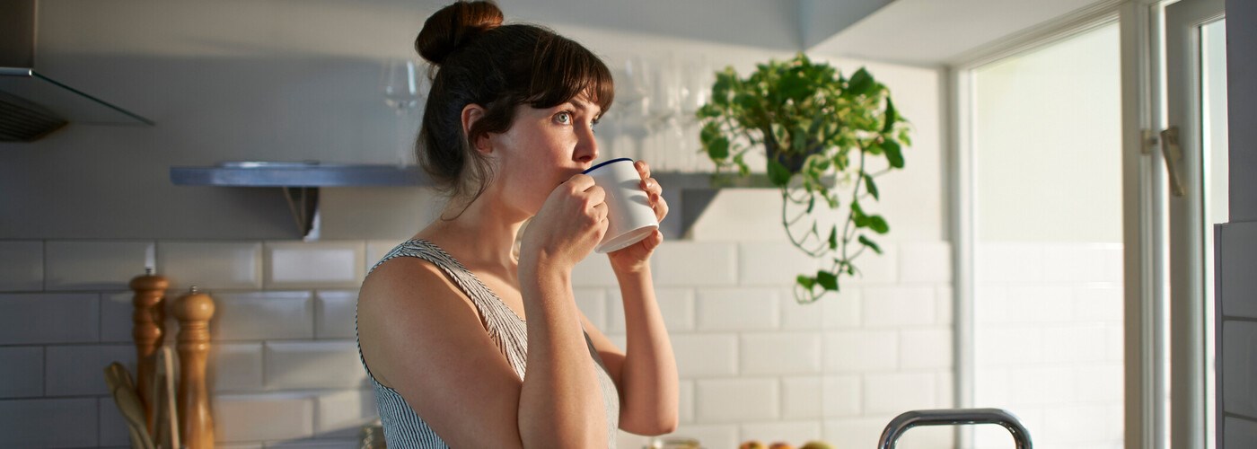 Lady drinking tea in the kitchen